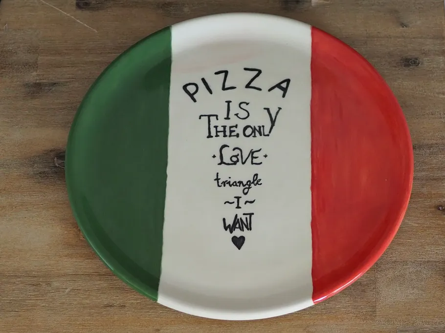 A plate shows pizza love in Italian colors.