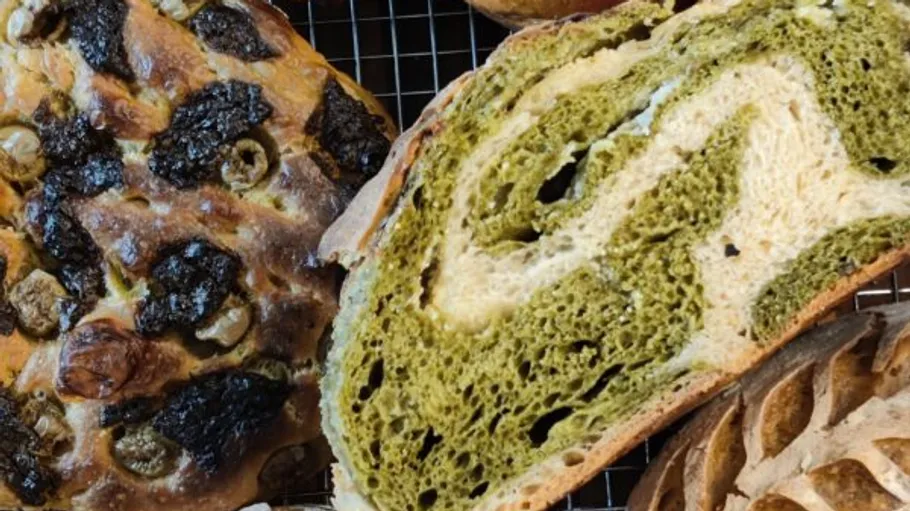 Sliced green and white swirl bread loaf.