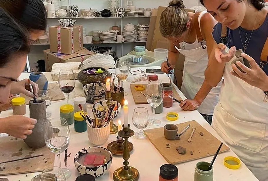 People crafting pottery in a workshop.
