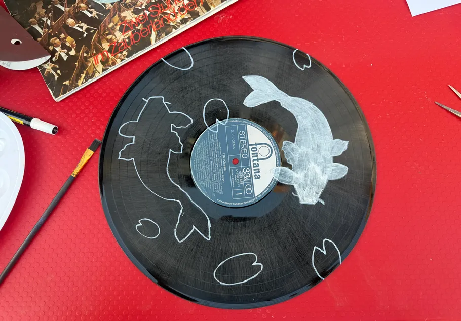 Painted record with koi fish design.