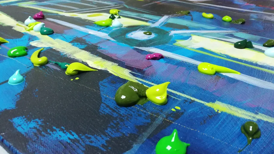 Colorful paint dabs on abstract canvas.