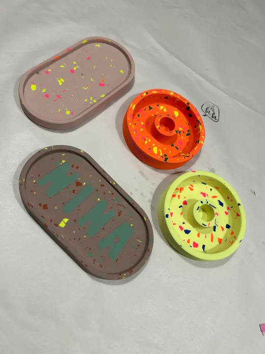 Bunte gesprenkelte Tabletts auf weißer Oberfläche.