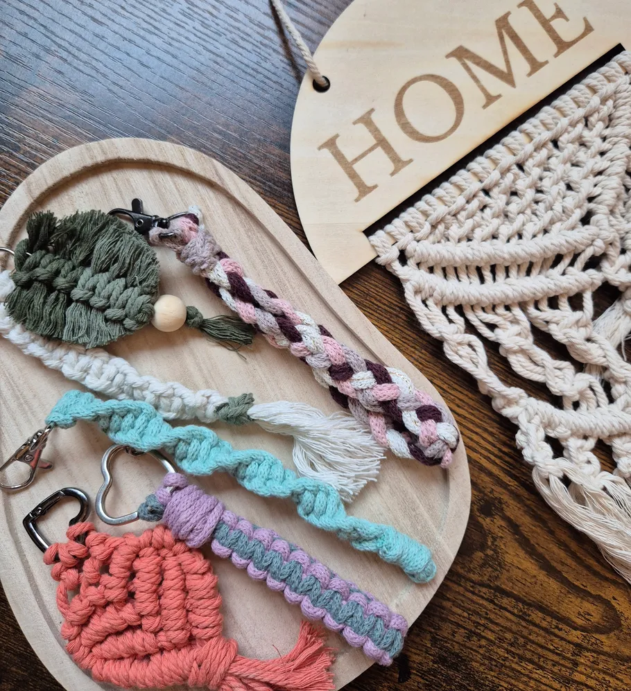 Colorful braided keychains on wooden board.