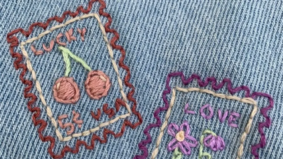 Embroidered stamps on denim fabric.
