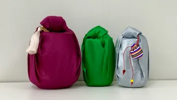 Three fabric-wrapped bottles on a shelf.