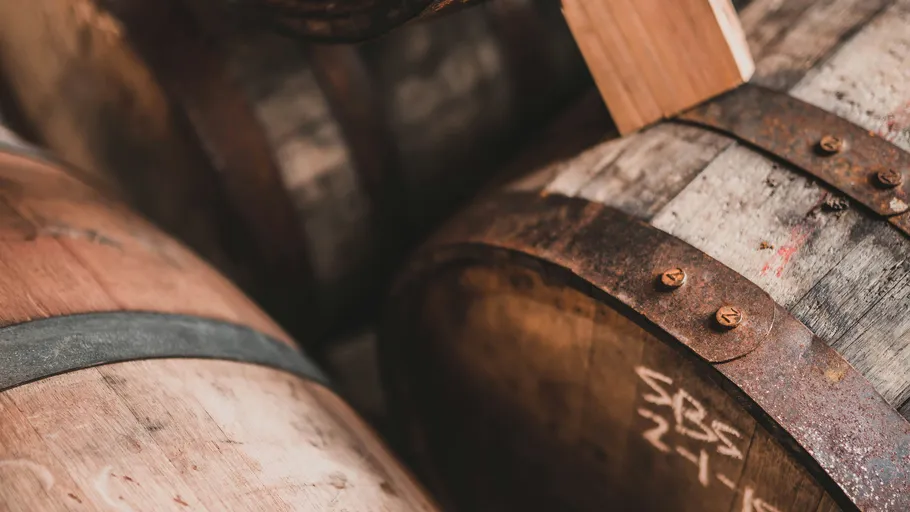Close-up of wooden barrels in storage.