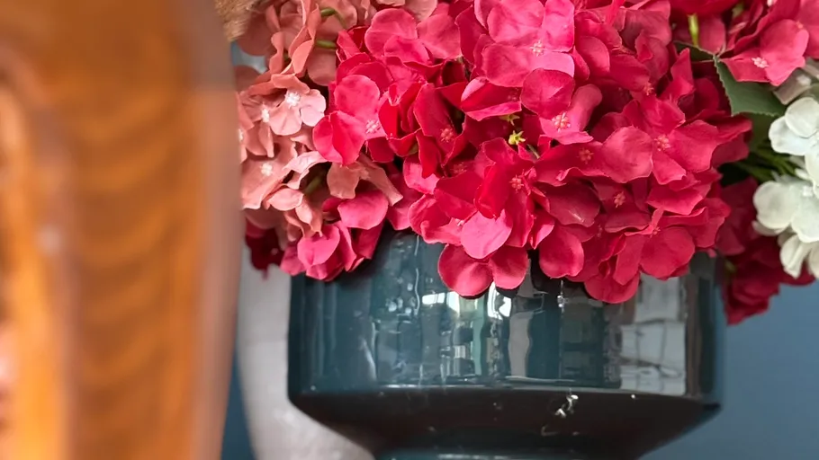 Pink hydrangeas in a blue vase.