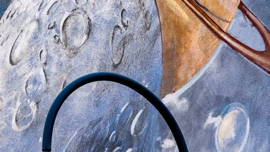 Wall mural depicting planets and abstract shapes.