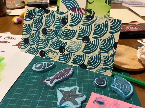 Hand-carved stamps and printed patterns on table.