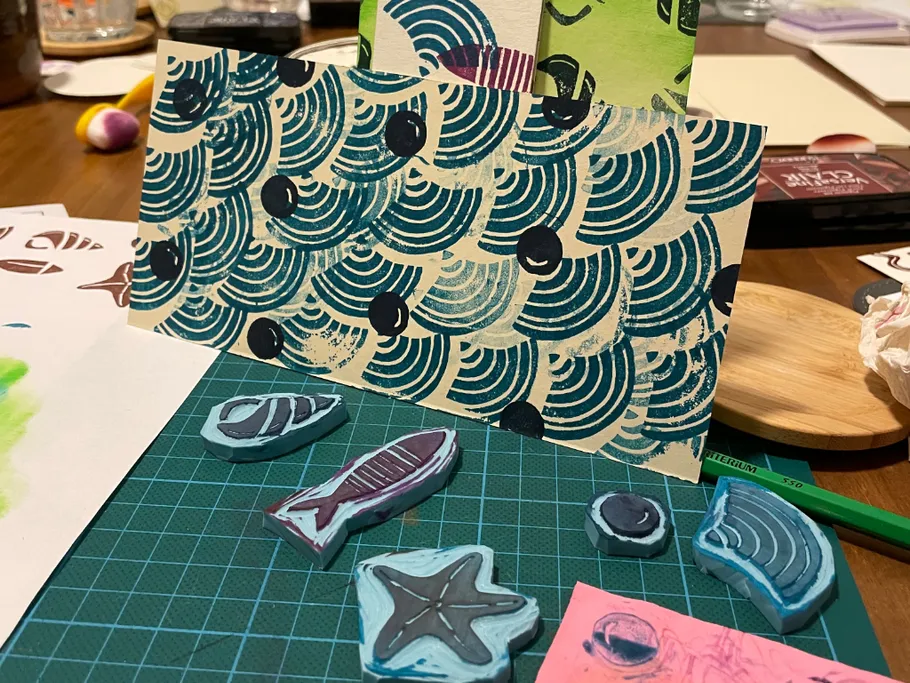 Hand-carved stamps and printed patterns on table.