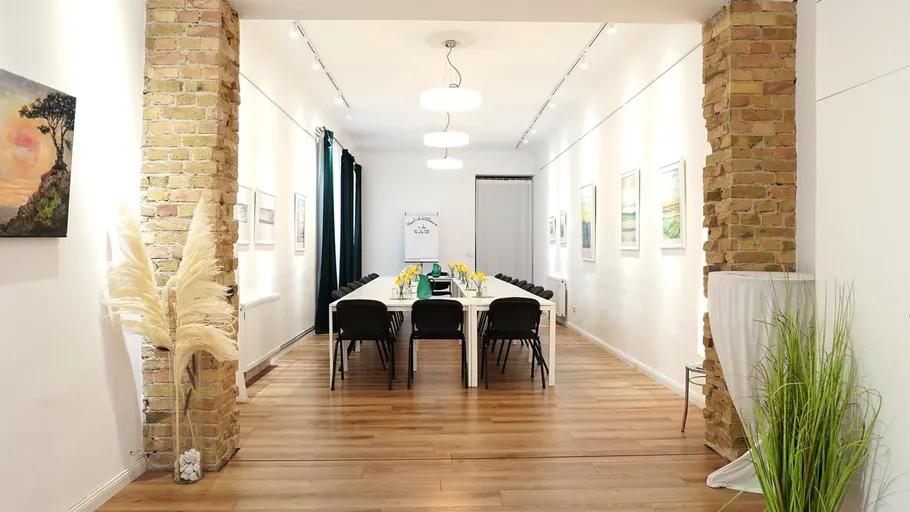 Long table with chairs in a bright room.
