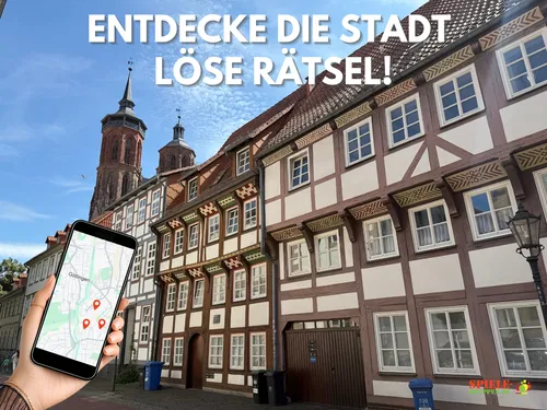 Hand holds phone with map, historic buildings visible.