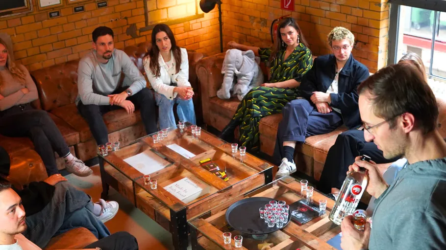 People sitting around table listening in cozy room.