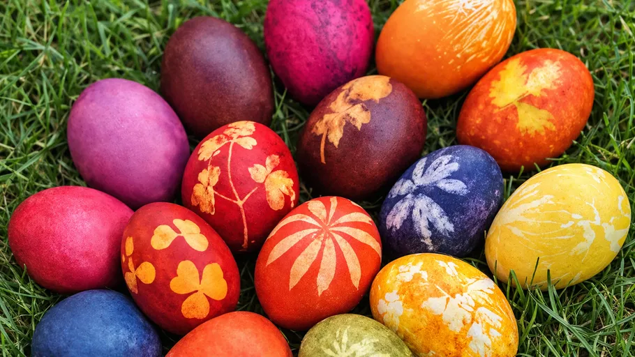 Colorful decorated eggs on green grass.