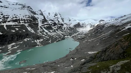 Snowy mountains surrounding a turquoise lake.