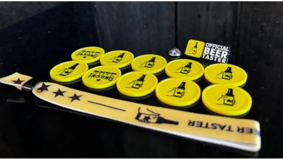 Yellow tokens and badge for beer tasting.
