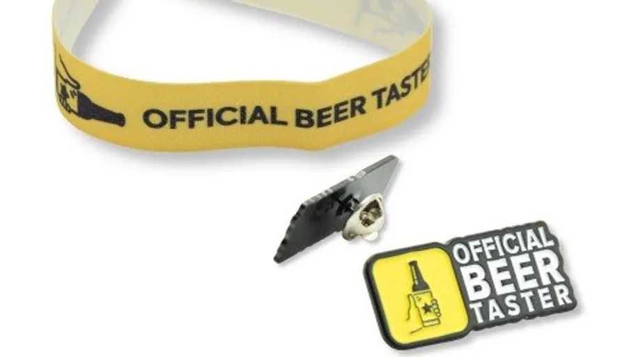 Yellow wristband and pin with 'Official Beer Taster'.