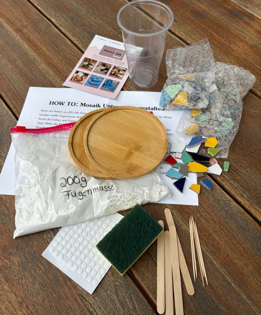 Mosaic materials and instructions on wooden table.
