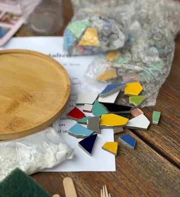Colorful mosaic tiles on wooden table.