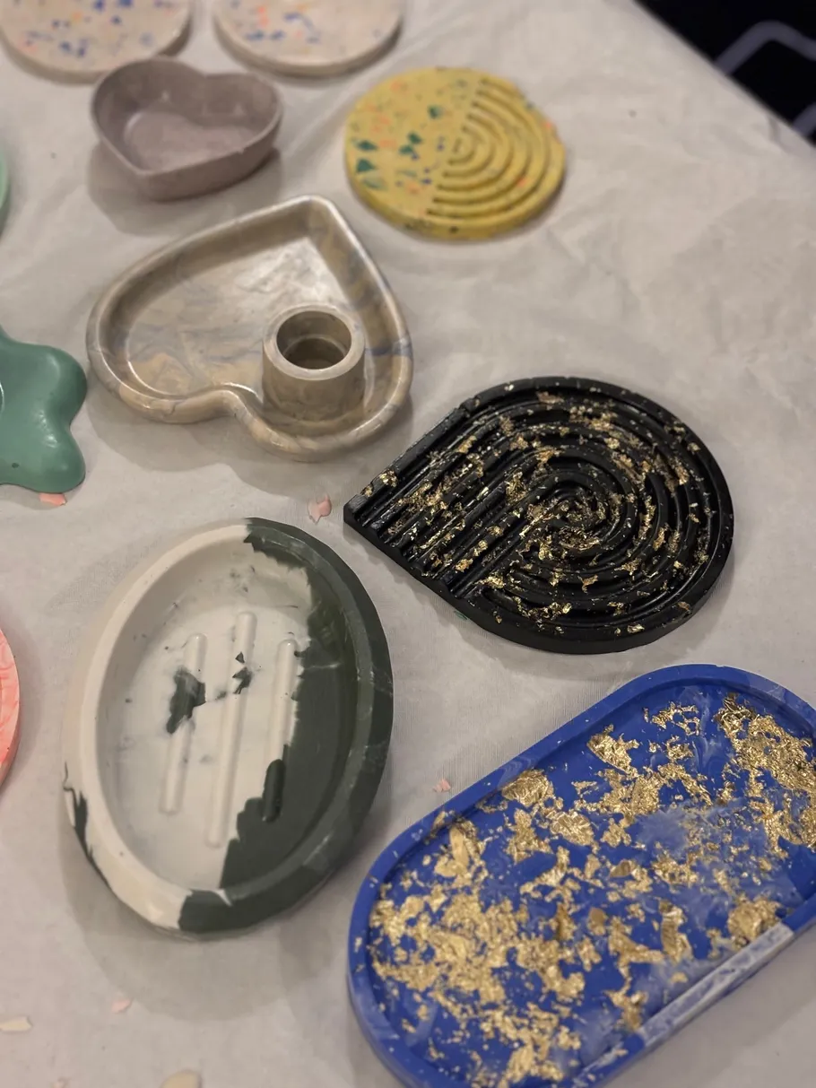 Various colorful resin trays on display table.