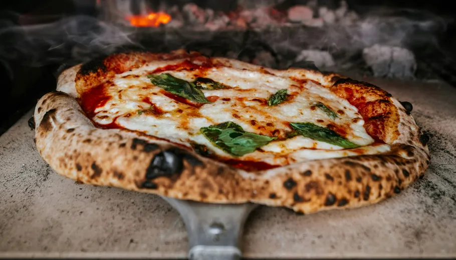 Pizza baking in a wood-fired oven.