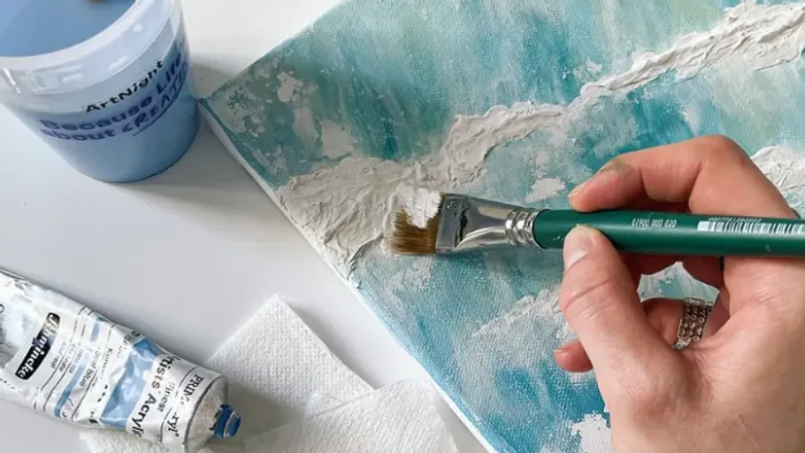 Hand painting textured white on blue canvas.