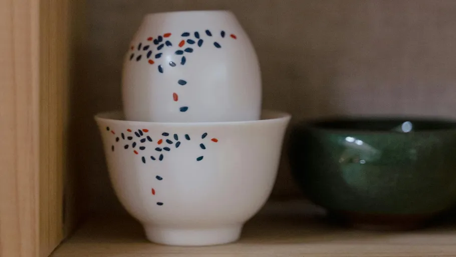 Two stacked cups with colorful dots design.