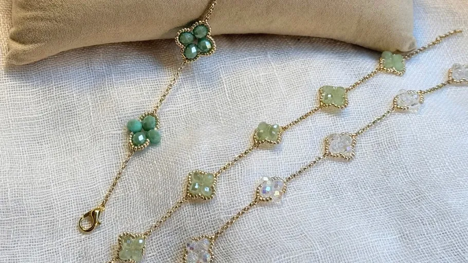 Beaded bracelet with floral design on fabric.