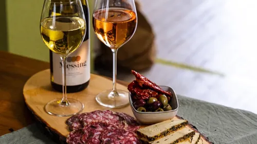 Charcuterie board with two glasses of wine.