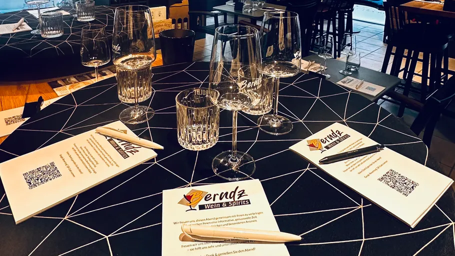 Wine tasting setup with glasses and notes.