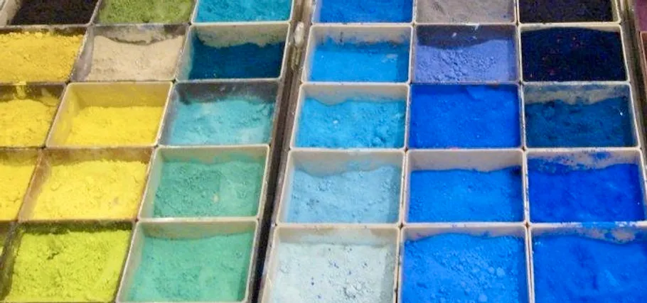 Colorful pigment powders in square containers.