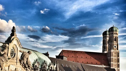 Cathedral domes and sculptures beneath cloudy sky.