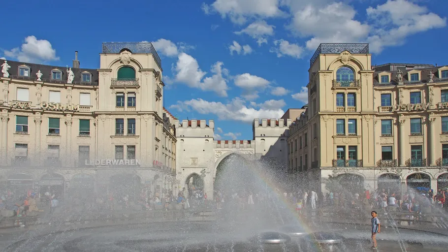 Fountain spraying water in urban plaza.