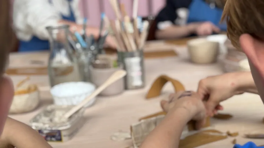 People crafting with tools on a table.