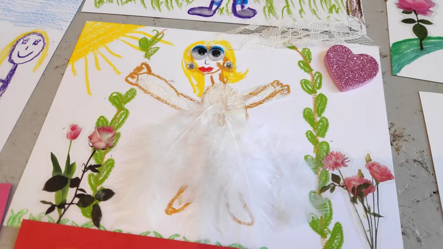 Child's drawing of a fairy with flowers.