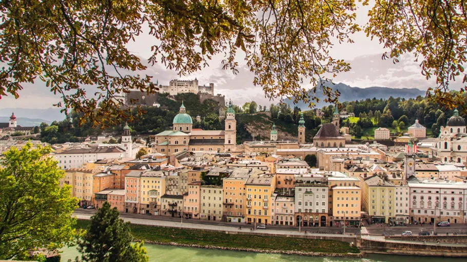 Cityscape of Salzburg with fortress in background.