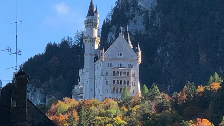 Castle on hill surrounded by autumn trees.