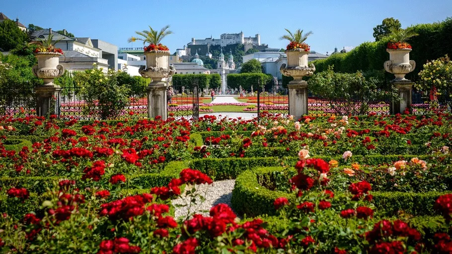 Colorful garden with castle in background.