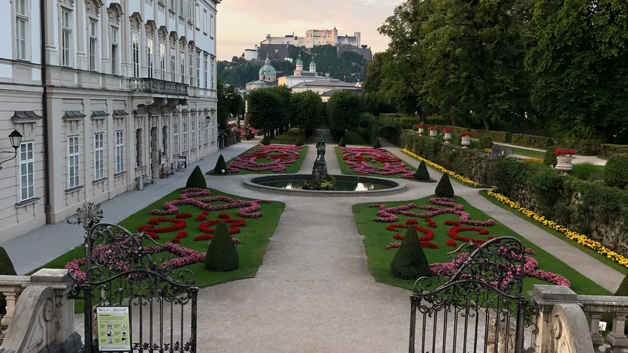 Garden with symmetrical flower beds and a fountain.