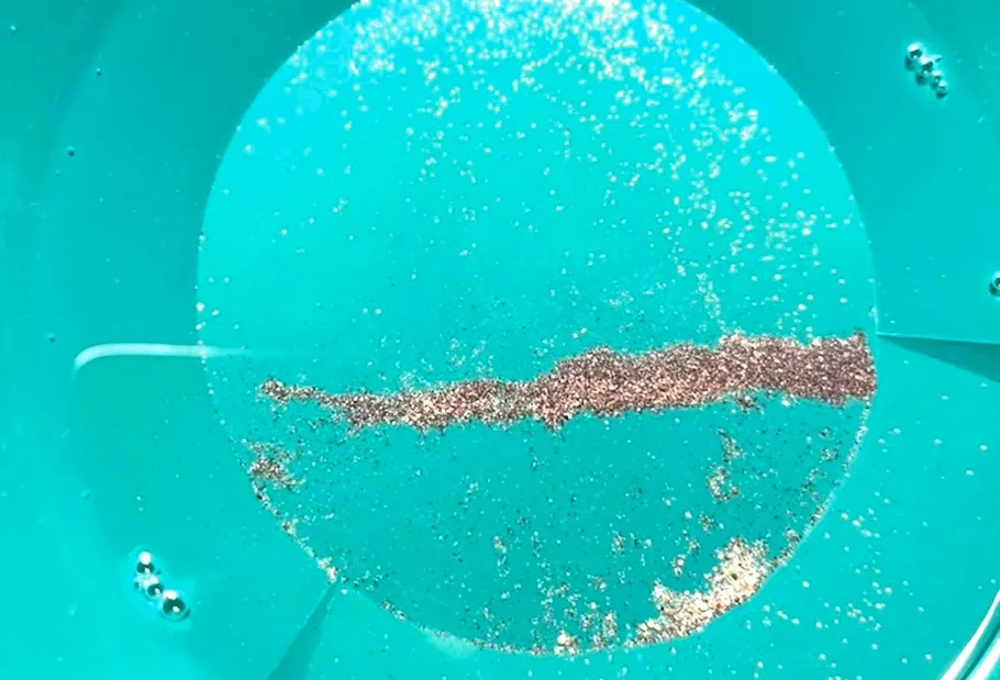 Gold specks in a turquoise pan.