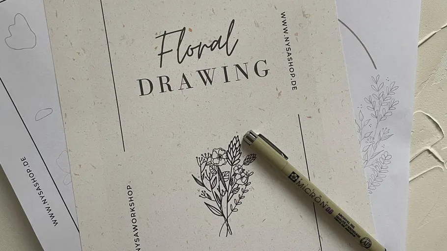 Floral drawing guide with pen on paper.