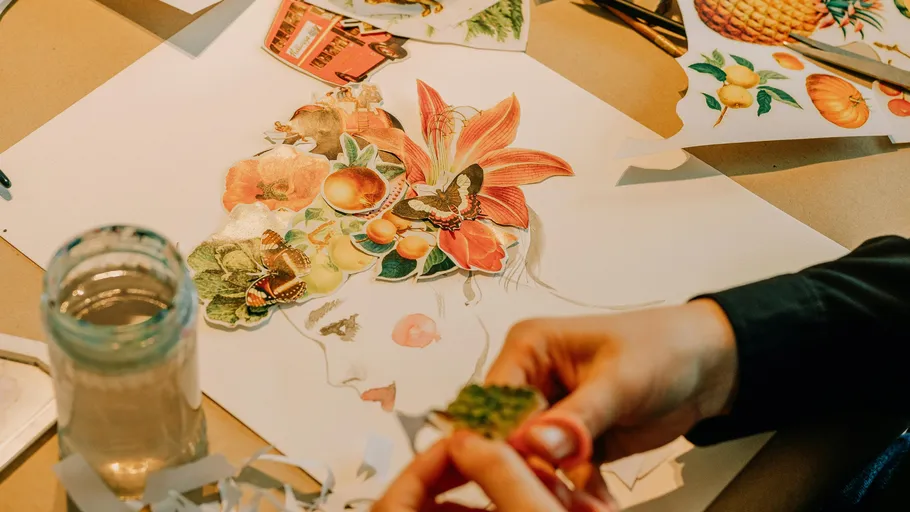 Person creating a colorful paper collage.