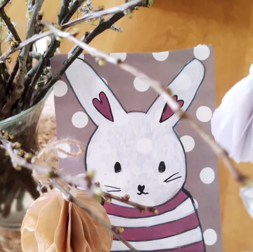 Drawing of bunny with polka dots, surrounded by branches.