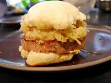 Rolls with ham and sauerkraut on a plate.
