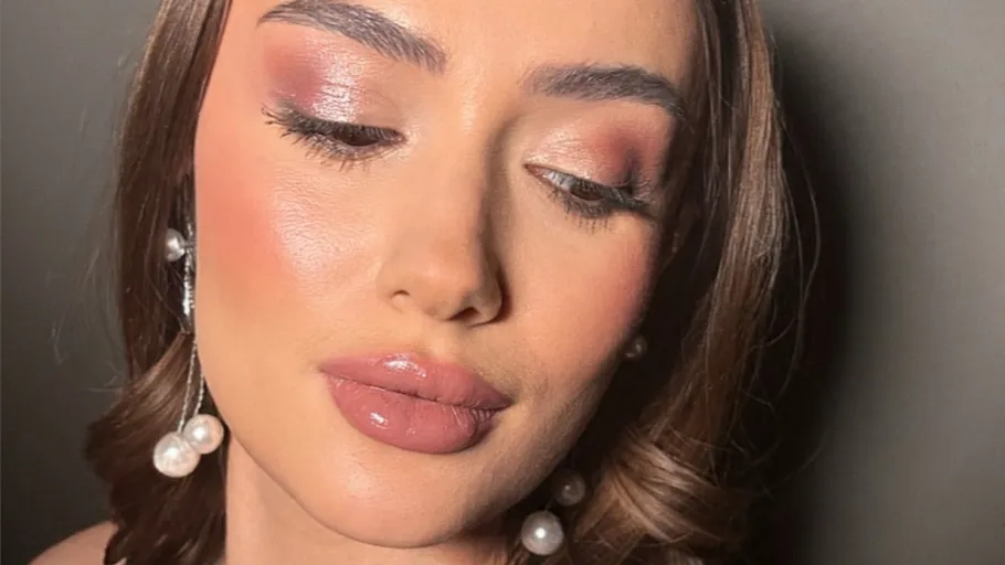 Woman with makeup and pearl earrings.