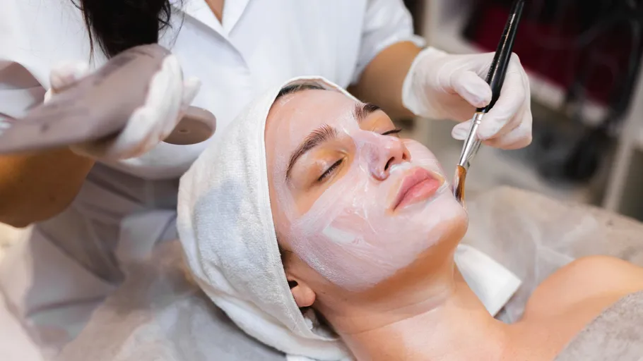 Woman receives facial treatment at a spa.