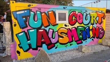 Colorful graffiti on a wall reading 'FUN COURT HAUSMENING'.