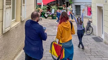 People walking in a colorful street scene.