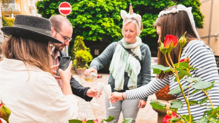 People toasting with drinks outdoors in garden.