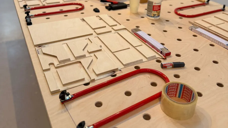 Wood pieces and tools on perforated table.